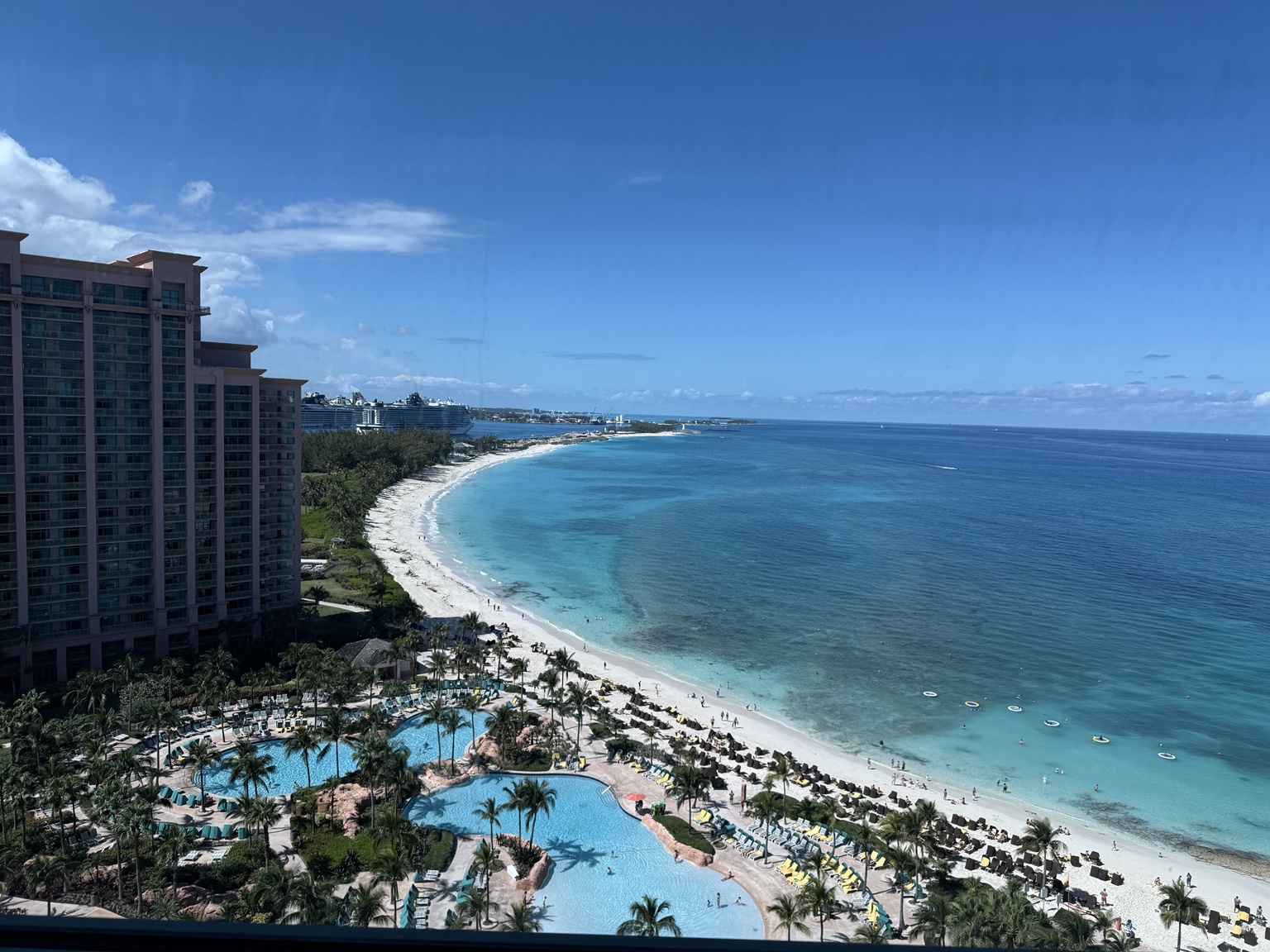 A high-floor view over pools, white sand beach and turquoise ocean at Atlantis Paradise Island