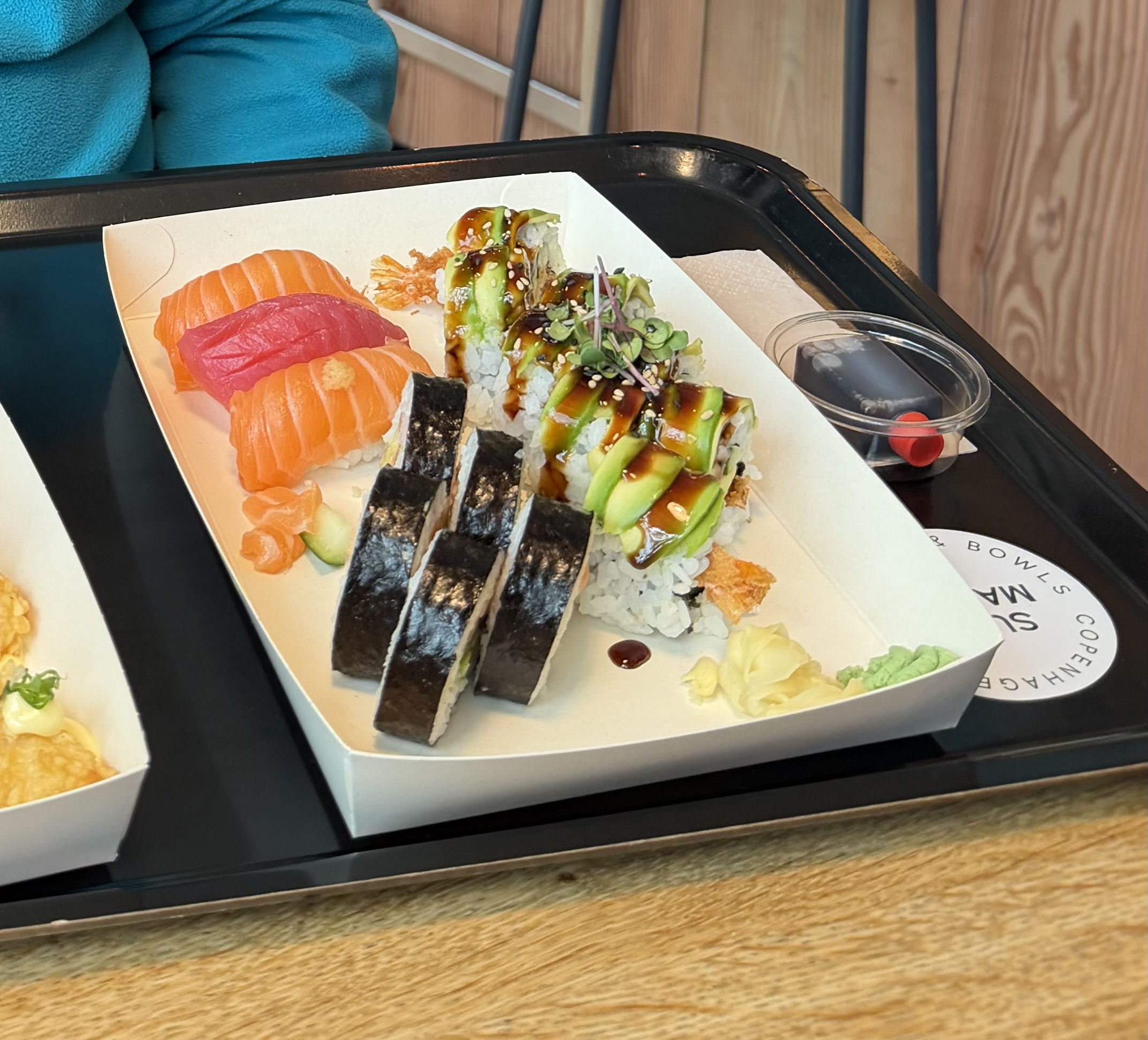 A tray of salmon and tuna nigiri, avocado-topped sushi rolls and seaweed-wrapped sushi