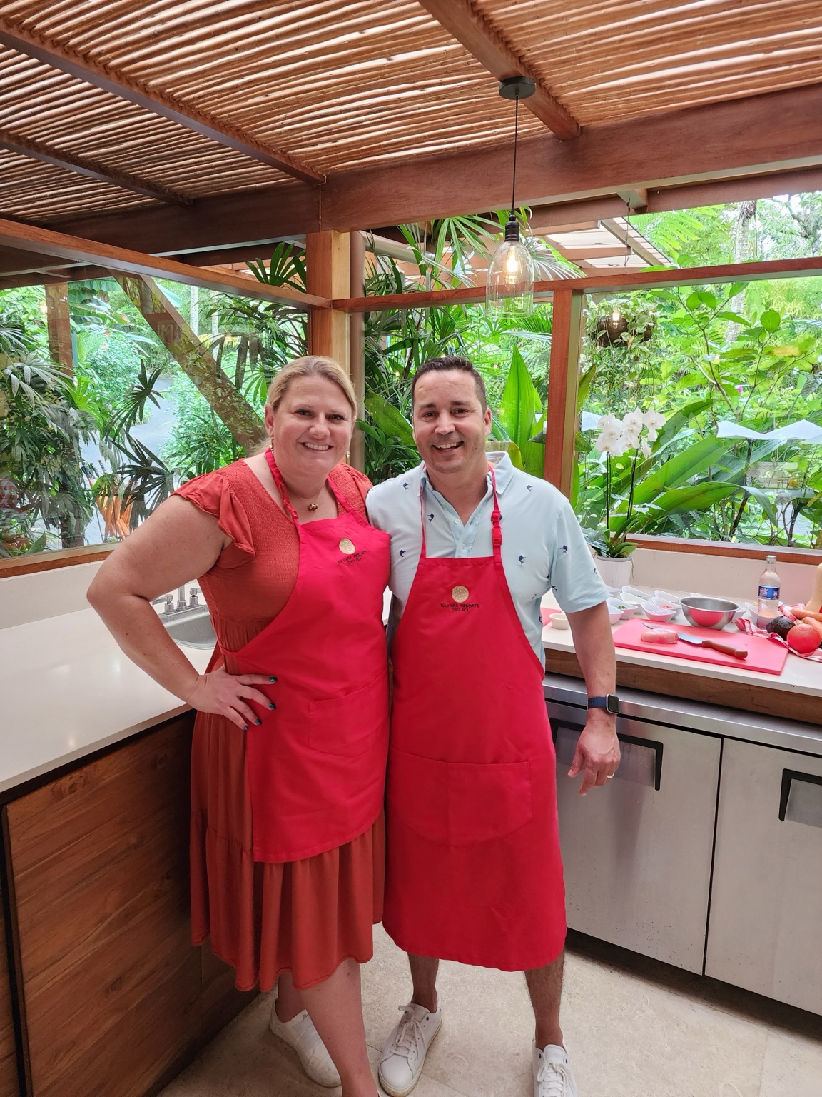 Jeni with an instructor during a cooking experience at Nayara