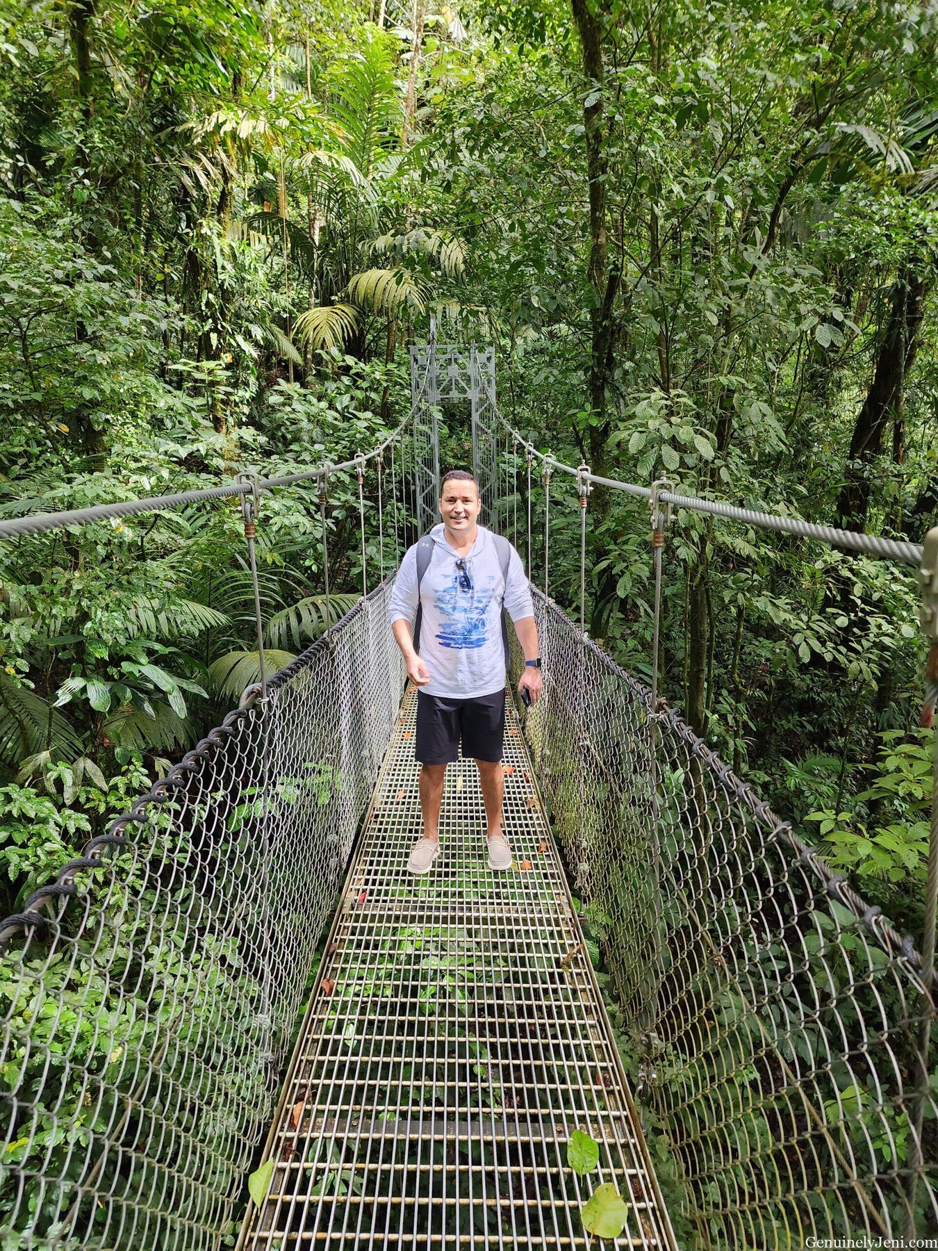 Hassan standing on a hanging bridge in the Arenal rainforest