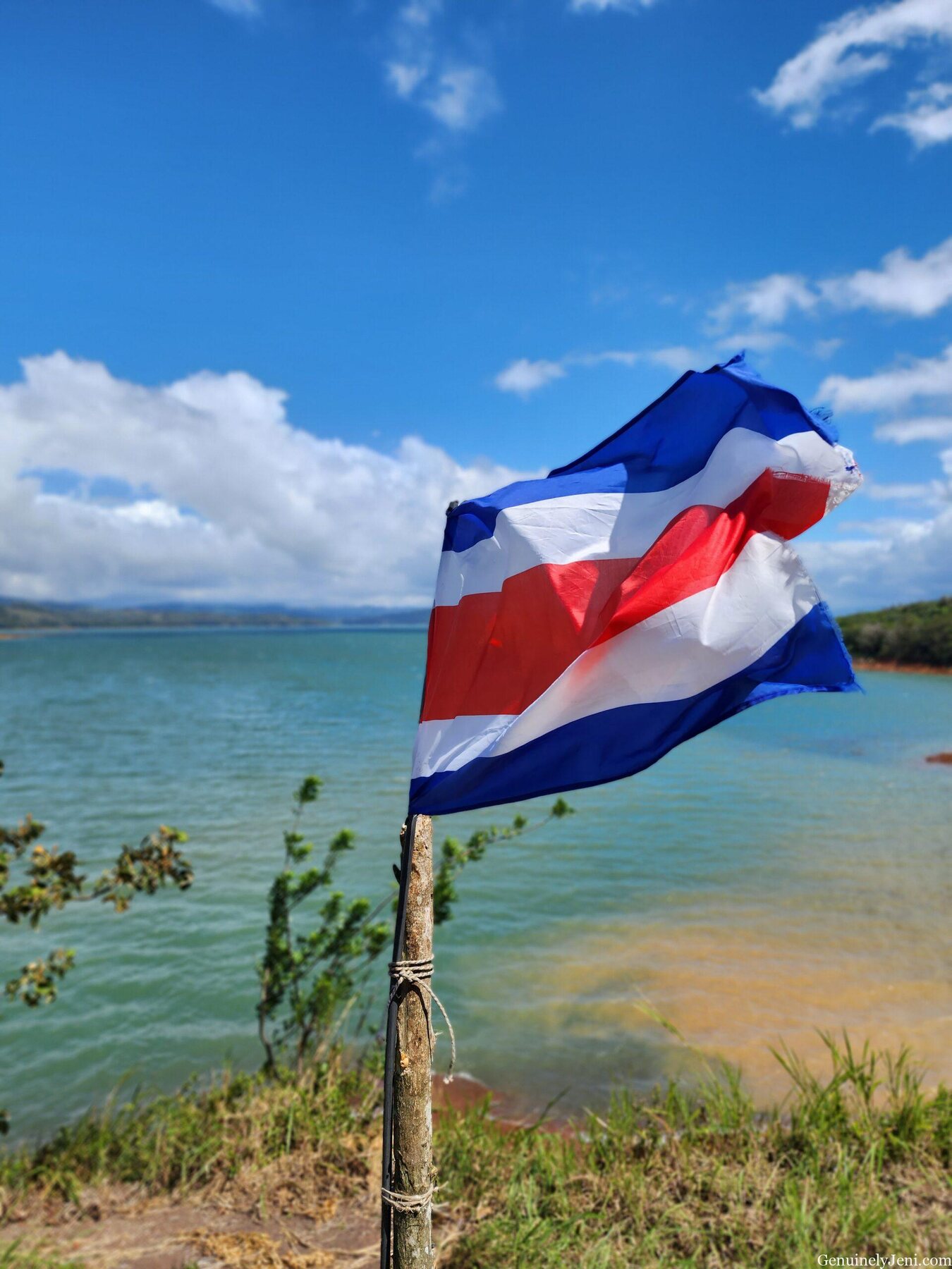 Costa Rican flag overlooking Lake Arenal during the drive between regions