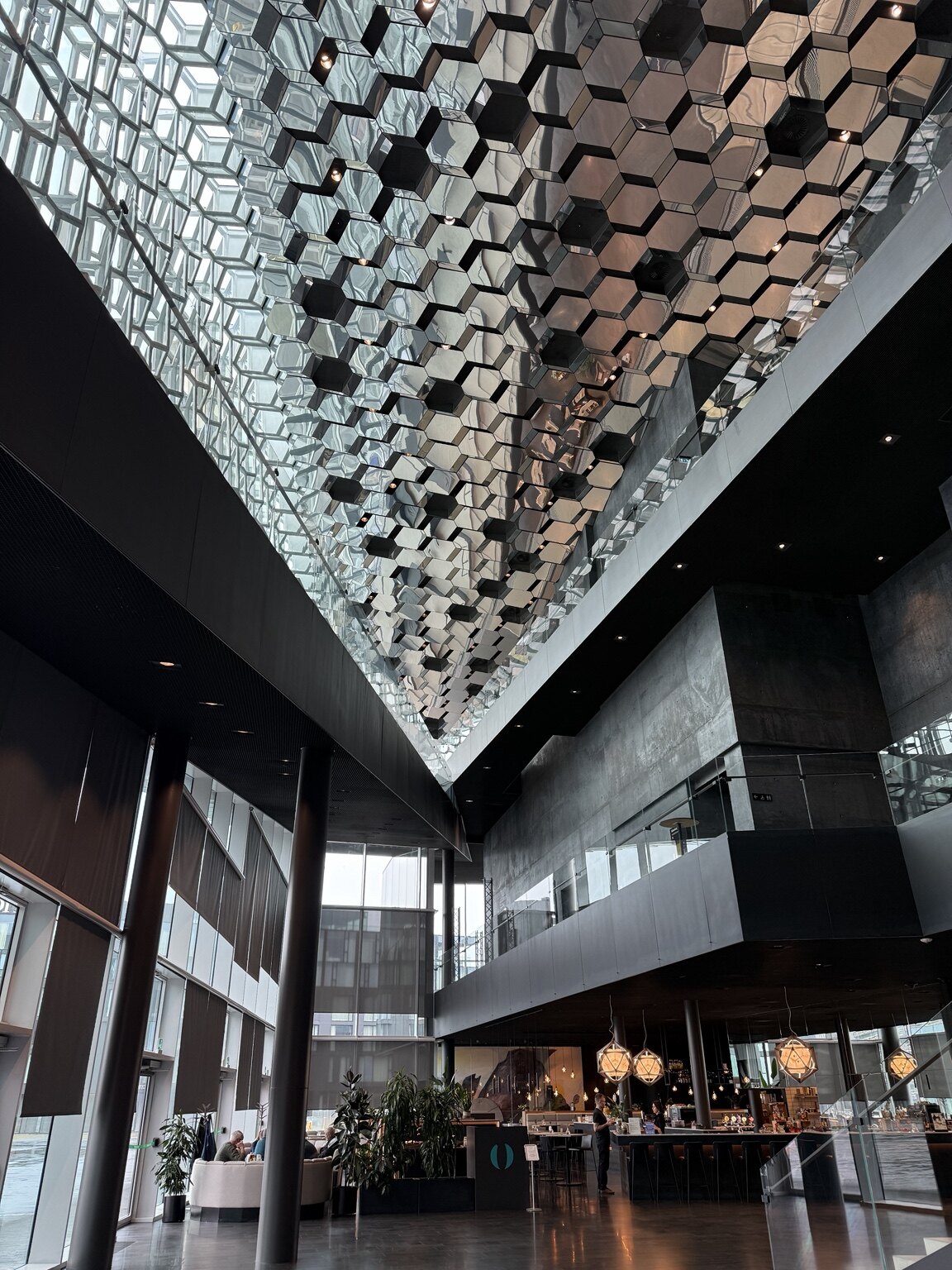 The geometric glass and mirrored interior of Harpa Concert Hall