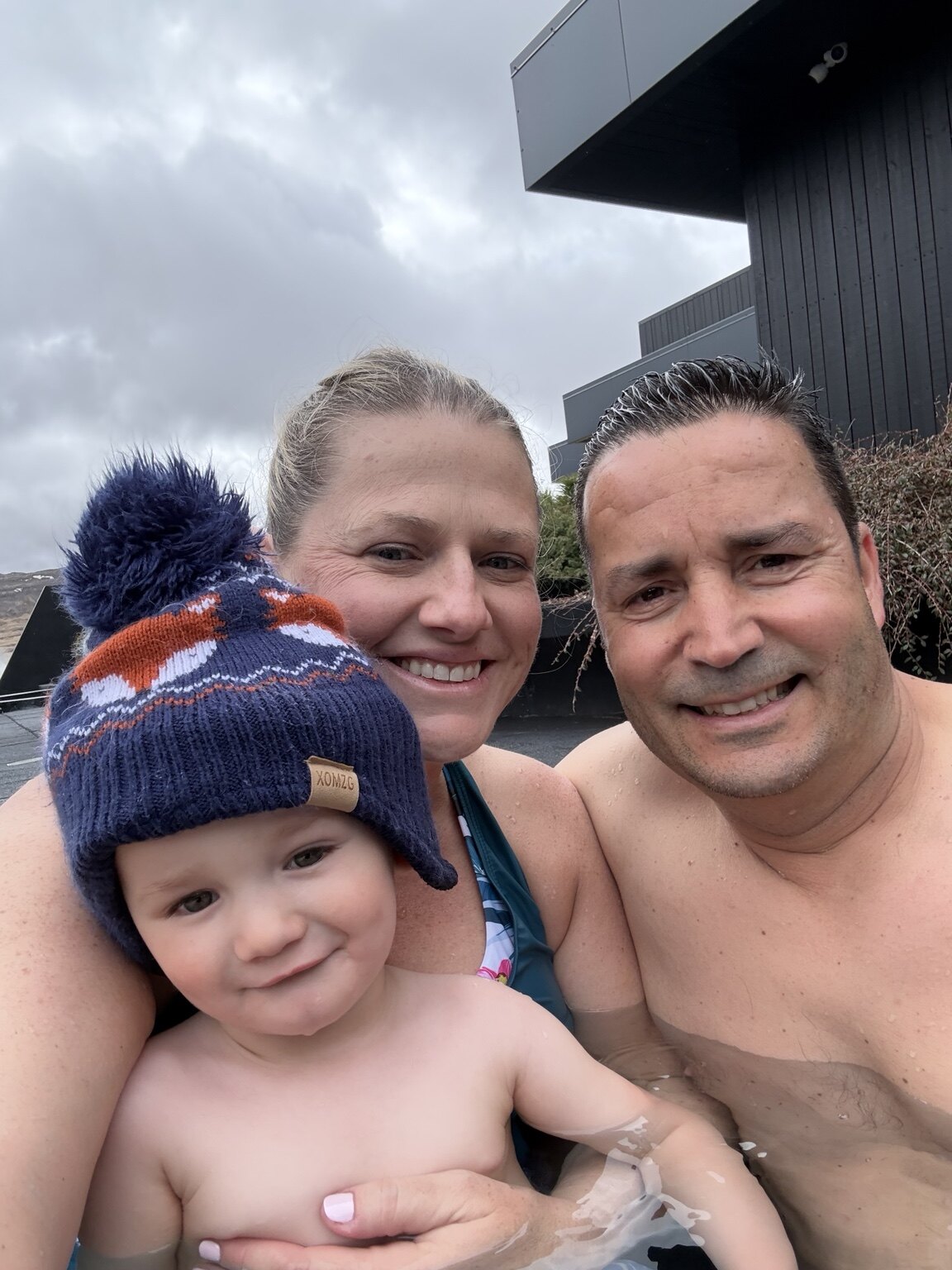 Jeni, Hassan and their toddler together in an outdoor geothermal pool at Krauma