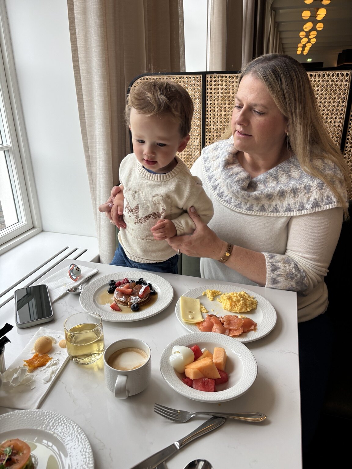 Jeni and her toddler sharing breakfast at Iceland Parliament Hotel