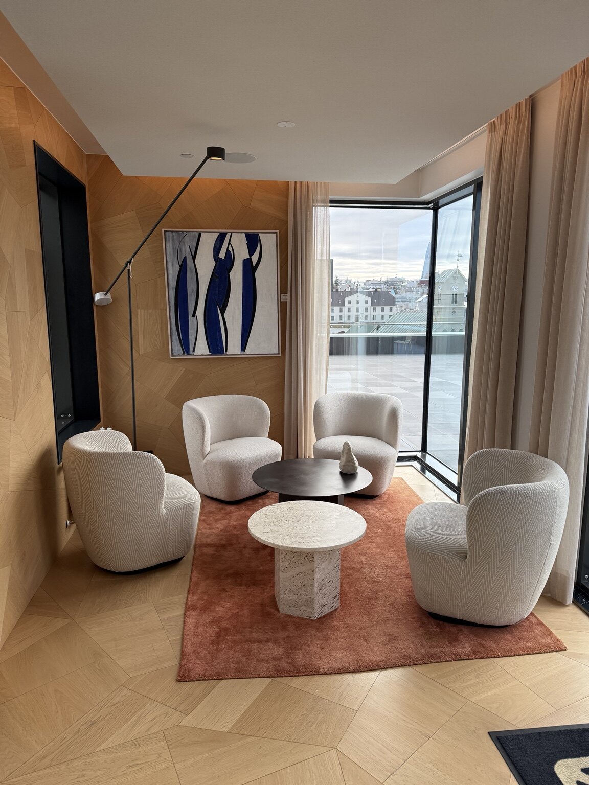 A light-filled lounge at Iceland Parliament Hotel overlooking central Reykjavík