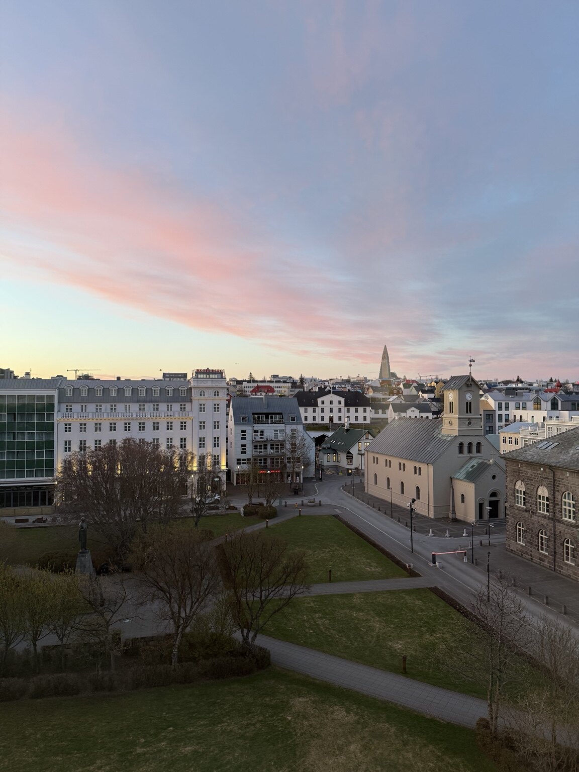 A pink May sunset over central Reykjavík viewed from Iceland Parliament Hotel