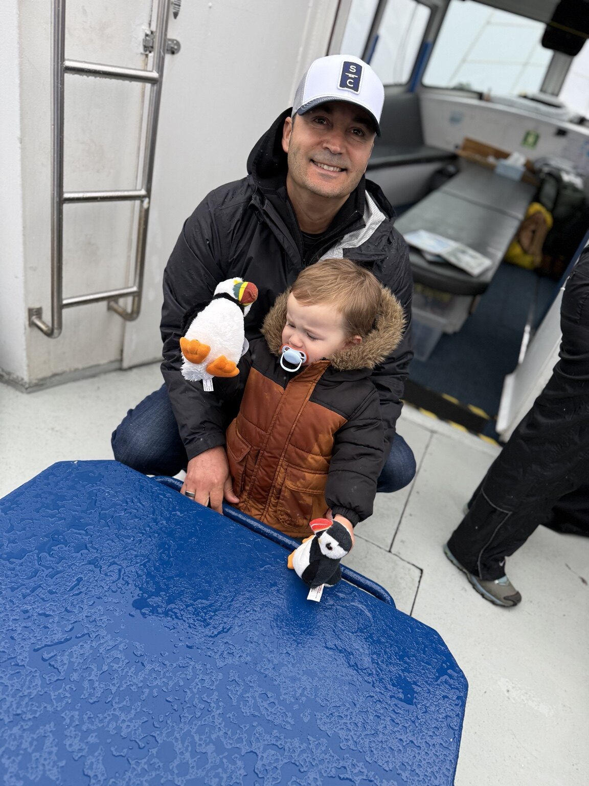 Hassan and his toddler aboard the Puffin Express boat in Reykjavík