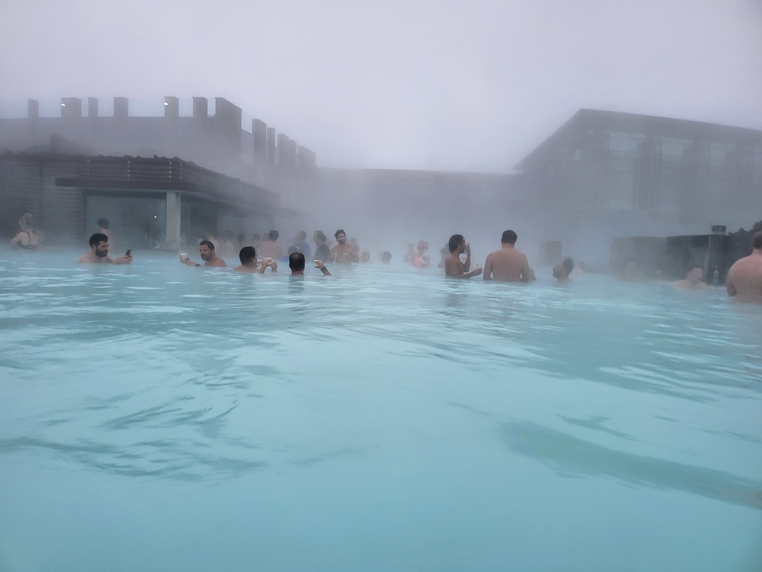 Guests gathered in the steaming geothermal water at Blue Lagoon