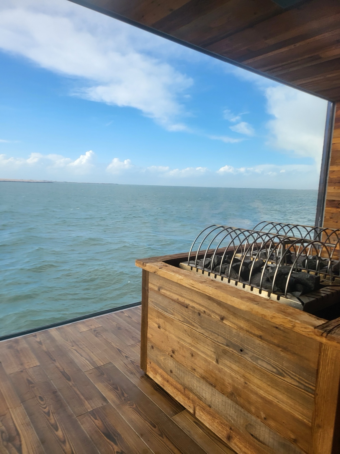 The ocean seen through the broad picture window inside Sky Lagoon's sauna