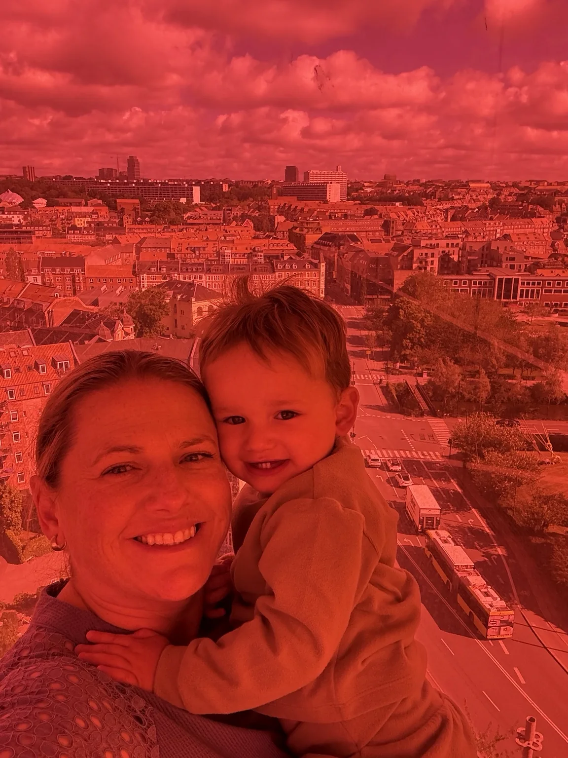 Jeni and her toddler inside the red section of the ARoS rainbow walkway