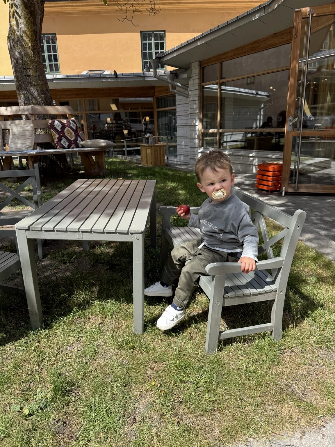Our toddler enjoying child-sized seating in the museum café courtyard