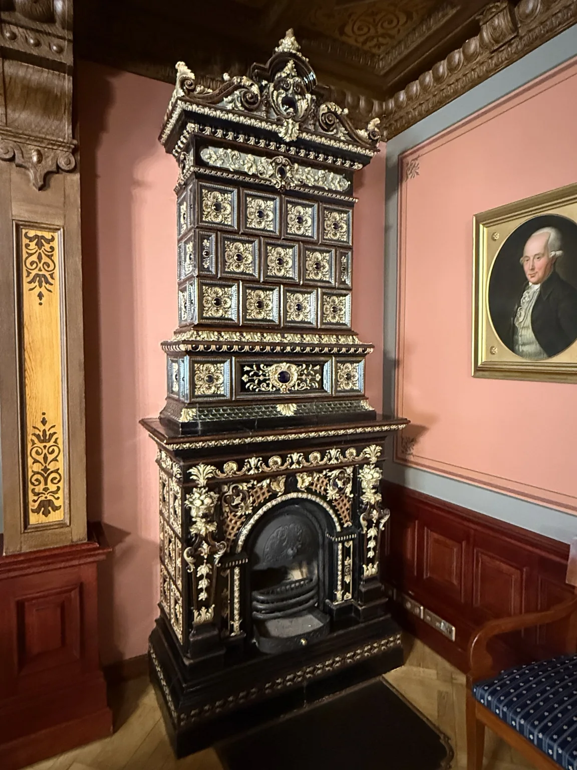 An ornate black and gold stove inside the House of the Black Heads