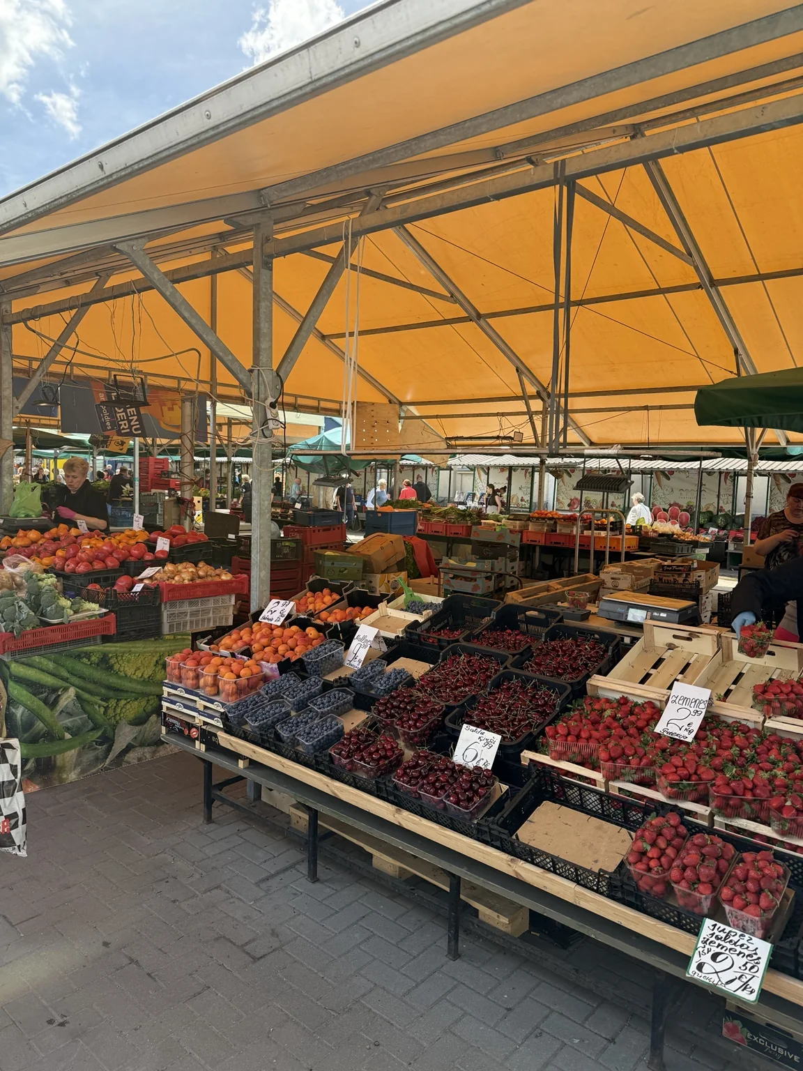 Fruit stalls with berries and cherries at the market in Riga