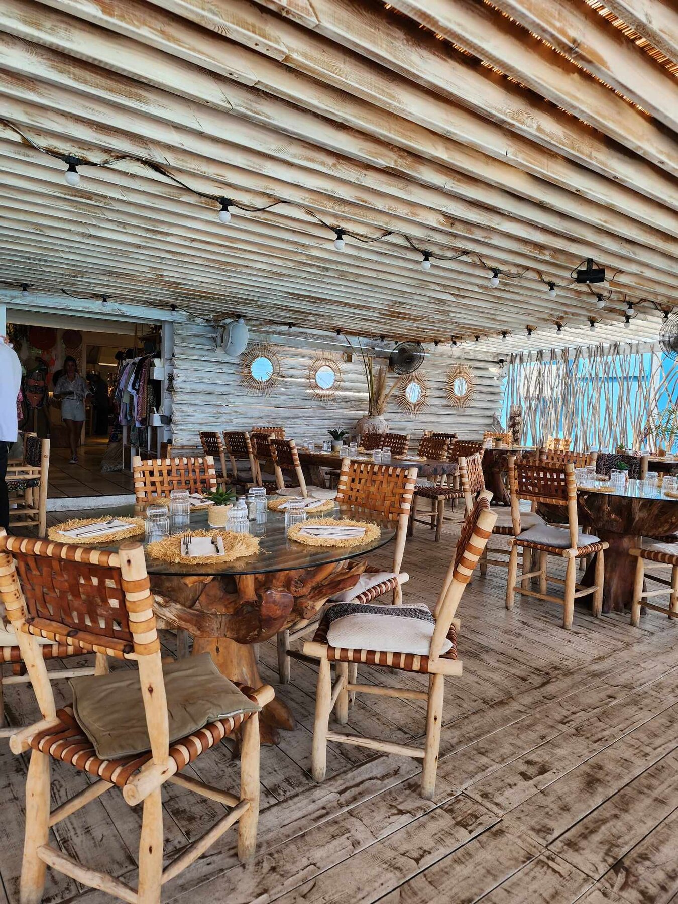 Open-air dining beside turquoise water at Rainbow Café in Grand Case